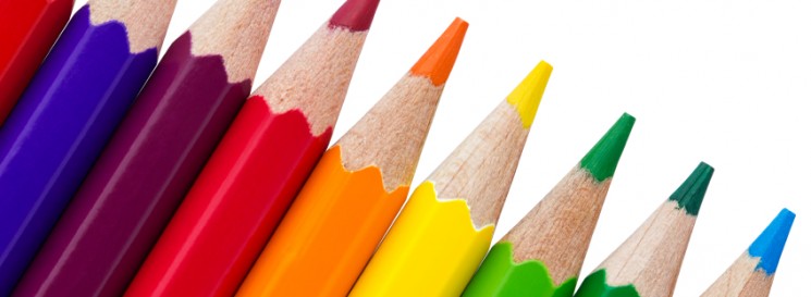 Row of colourful pencils isolated over white background